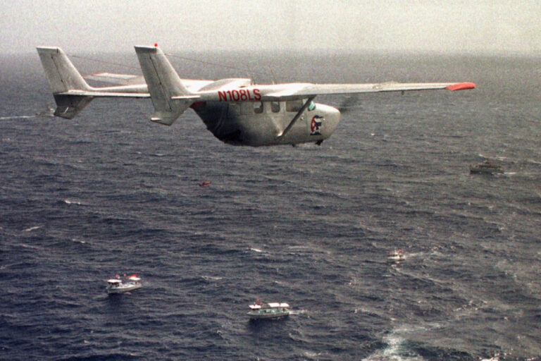 A Brothers to the Rescue plane flies over The Democracy Movement flotilla at the twelve-mile limit north of Havana, Cuba, July 10, 1999. (AP Photo/Alan Diaz, File)