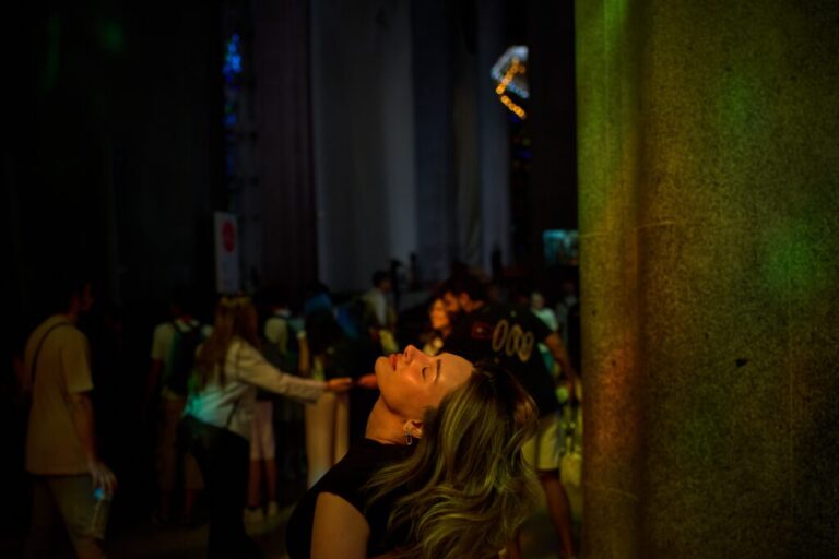 A visitor looks up inside Antoni Gaudí's Basilica of the Sagrada Familia as colored light from its stained-glass windows illuminates the interior in Barcelona, Spain, Tuesday, May 26, 2026, ahead of Pope Leo XIV's visit to the city in June. (AP Photo/Emilio Morenatti)