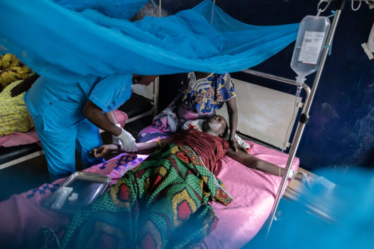 A nurse gives painkillers to patient Amna Adam Hessen, whose baby was delivered stillborn the previous day, at the Birao District Hospital in the Central African Republic, Wednesday, March 25, 2026. (AP Photo/Caitlin Kelly)