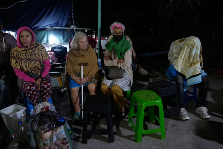 People remain outside their homes following an earthquake in Caracas, Venezuela, Thursday, June 25, 2026. (AP Photo/Ariana Cubillos)