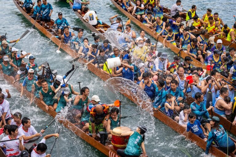 Competitors splash water on each other during the Aberdeen Dragon Boat Race to celebrate the Dragon Boat Festival in Hong Kong, Friday, June 19, 2026. (AP Photo/Chan Long Hei)