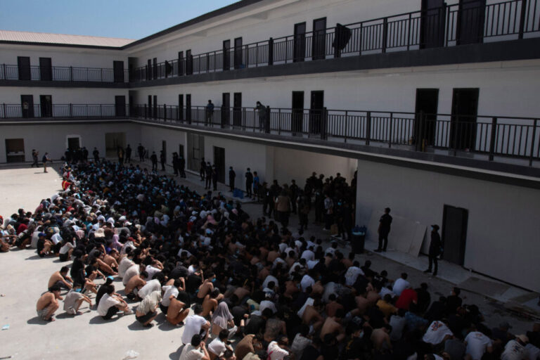 People from China, Vietnam and Ethiopia, believed to have been trafficked and forced to work in scam centers, sit with their faces masked while in detention after being released from the centers in Myawaddy district in eastern Myanmar, Feb. 26, 2025. (AP Photo/Thanaphon Wuttison, File)
