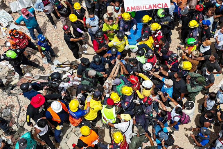 A person removed from the rubble by members of the French Civil Security Training and Intervention Regiment (UIISC 7), U.S. rescuers and others is carried on a stretcher to an ambulance along the coast in Caraballeda, La Guaira state, Venezuela, Sunday, June 28, 2026, after earthquakes. (Miguel Medina, Pool photo via AP)