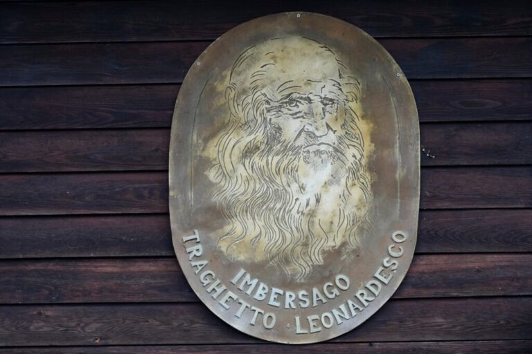 An effigy of Leonardo da Vinci hangs on the dock of the “Da Vinci Ferry,” a hand-operated of a type sketched by Leonardo da Vinci in the 15th century, on the Adda River between the provinces of Lecco and Bergamo, in Imbersago, Italy, Thursday, June 4, 2026. (AP Photo/Luca Bruno)