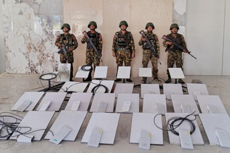 In this image provided by the Myanmar military on Oct. 19, 2025, soldiers stand next to Starlink satellite internet devices from the KK Park scam compound in Myawaddy township, Karen State, Myanmar. (The Myanmar Military True News Information Team via AP, File)