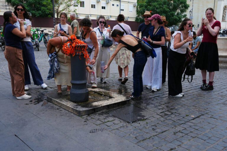 People cool off at a fountain in Rome, Tuesday, June 23, 2026. (AP Photo/Alessandra Tarantino)