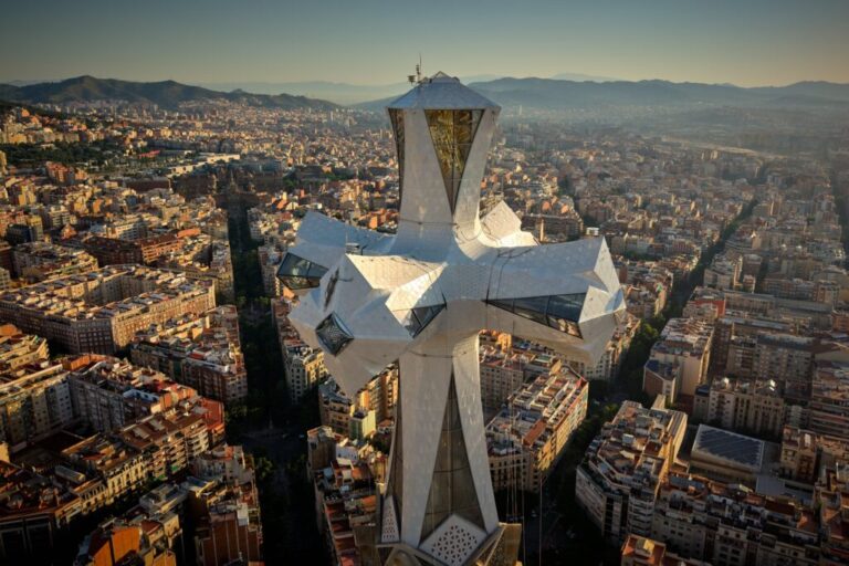 The cross crowns the 172.5-meter (566-foot) Tower of Jesus Christ at the Sagrada Familia basilica in Barcelona, Spain, Thursday, May 28, 2026, ahead of Pope Leo XIV's visit to the city in June. (AP Photo/Emilio Morenatti)
