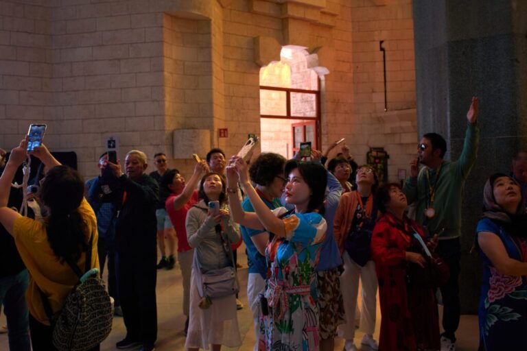 Visitors take photos inside Antoni Gaudí's Basilica of the Sagrada Familia in Barcelona, Spain, Tuesday, May 26, 2026, ahead of Pope Leo XIV's visit to the city in June. (AP Photo/Emilio Morenatti)
