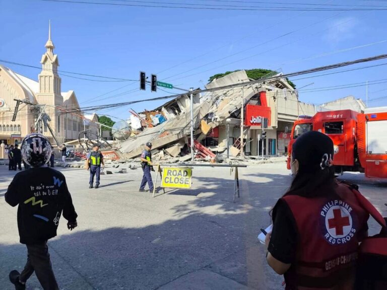 In this photo provided by the Philippine Red Cross, rescuers inspect the damage after an earthquake in General Santos, Philippines, Monday, June 8, 2026. (Philippine Red Cross via AP)