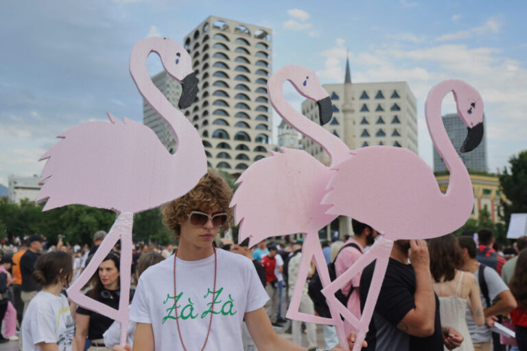 Protesters hold pink flamingo cutouts during a demonstration in Tirana, Albania, Wednesday, June 3, 2026, opposing a luxury coastal development project linked to Jared Kushner and Ivanka Trump over concerns about environmental impacts and transparency. (AP Photo/Hameraldi Agolli)