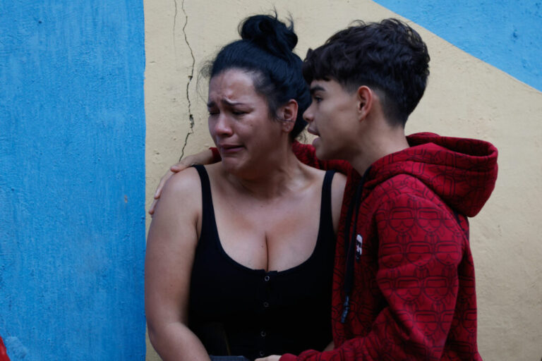 A boy comforts his mother after an earthquake in Caracas, Venezuela, Wednesday, June 24, 2026. (AP Photo/Pedro Mattey)