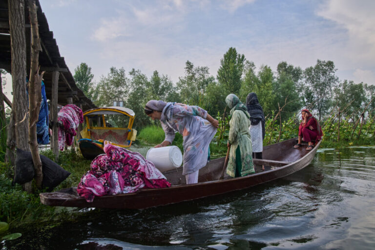 Kashmiri women on a boat wash blankets in the interiors of Dal Lake in Srinagar, Monday, June 1, 2026. (AP Photo/Dar Yasin)