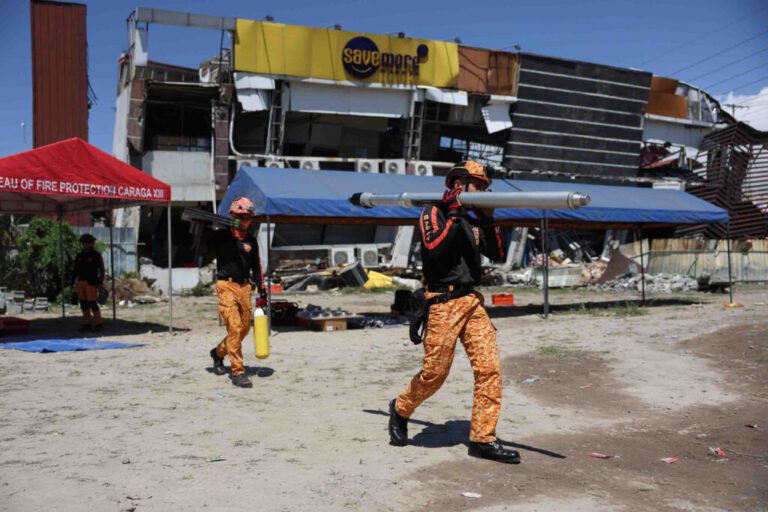 Rescuers prepare their equipment for a search operation at a damaged building following an earhtquake in General Santos, Philippines Tuesday, June 9, 2026. (AP Photo/Basilio Sepe)