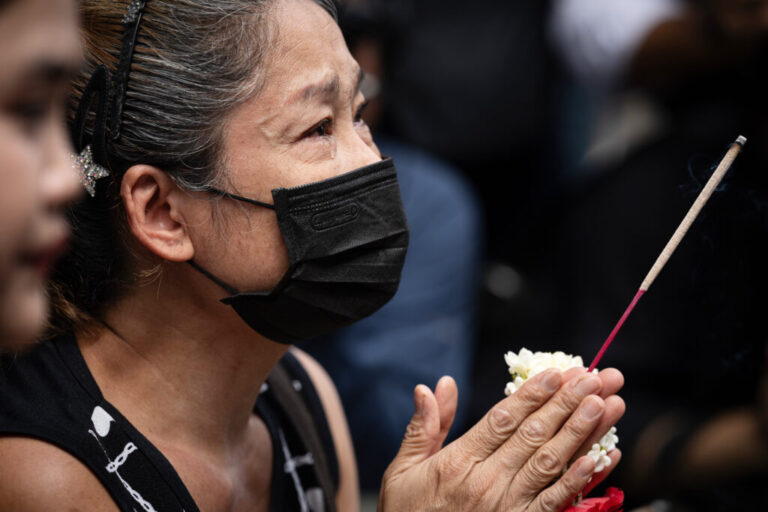 A woman weeps as she prays outside the music bar where a fire killed a number of people in Bangkok, Thailand, Tuesday, July 14, 2026. (AP Photo/Wason Wanichakorn)