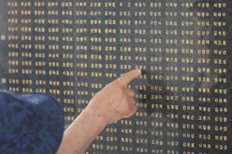 A South Korean man points a name of his brother who was killed in the Korean War in Seoul, South Korea, Sunday, July 5, 2026. (AP Photo/Lee Jin-man)