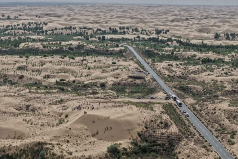 A highway cuts through a desertification control site of the Engebei Ecological Area near Ordos in northern China's Inner Mongolia province on Friday, June 12, 2026. (AP Photo/Ng Han Guan)