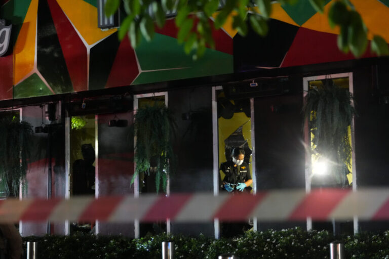 Forensic police officers inspect the site of a fire in Bangkok, Thailand, Monday, July 13, 2026. (AP Photo/Sakchai Lalit)