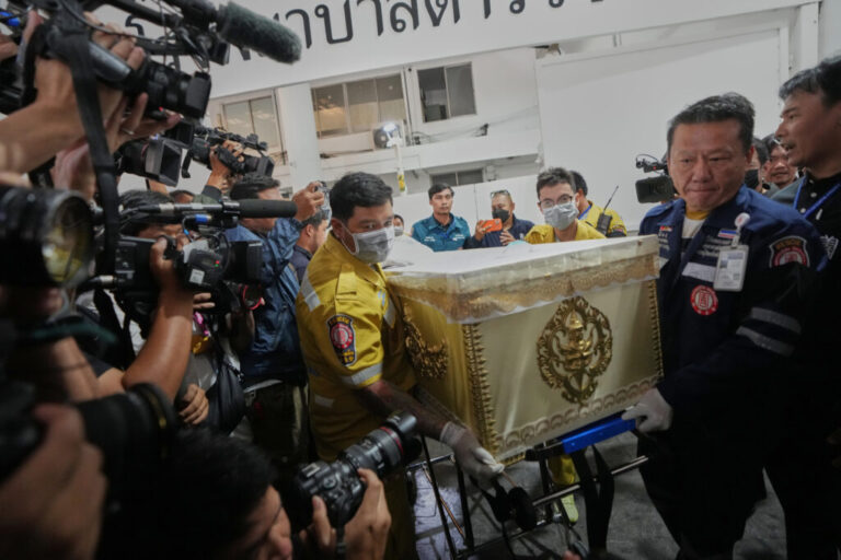 A coffin of a victim in a music bar fire is prepared to be handed over to the relatives, unseen, at a police hospital in Bangkok, Thailand, Tuesday, July 14, 2026. (AP Photo/Sakchai Lalit)