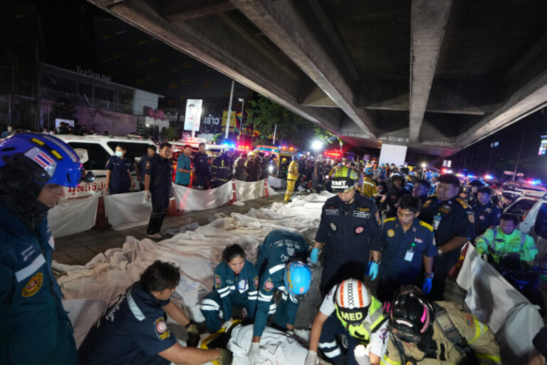 Bodies of victims of a fire are seen laid in a row in Bangkok, Thailand, Monday, July 13, 2026. (AP Photo/Sakchai Lalit)