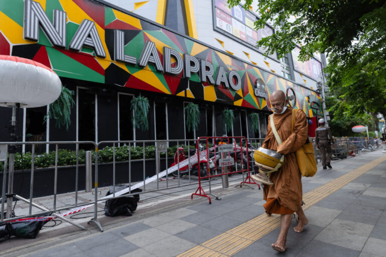 A Buddhist monk walks outside the music bar where a fire killed a number of people in Bangkok, Thailand, Tuesday, July 14, 2026. (AP Photo/Wason Wanichakorn)