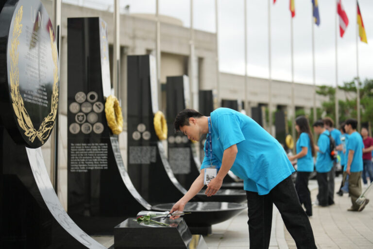 South Korean Jo Suk-hyun places flower at Korean War veterans memorial in Seoul, South Korea, Sunday, July 5, 2026. (AP Photo/Lee Jin-man)