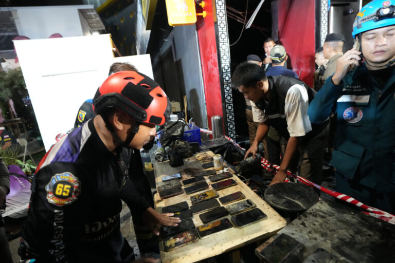 Mobile phones of victims of a fire are recovered in Bangkok, Thailand, Monday, July 13, 2026. (AP Photo/Sakchai Lalit)