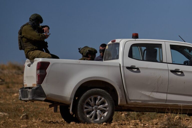A blindfolded Palestinian is detained by Israeli soldiers after being accused by Israeli settlers of setting a field on fire near the West Bank village of Susya, in the Masafer Yatta region, Thursday, June 18, 2026.(AP Photo/Leo Correa)