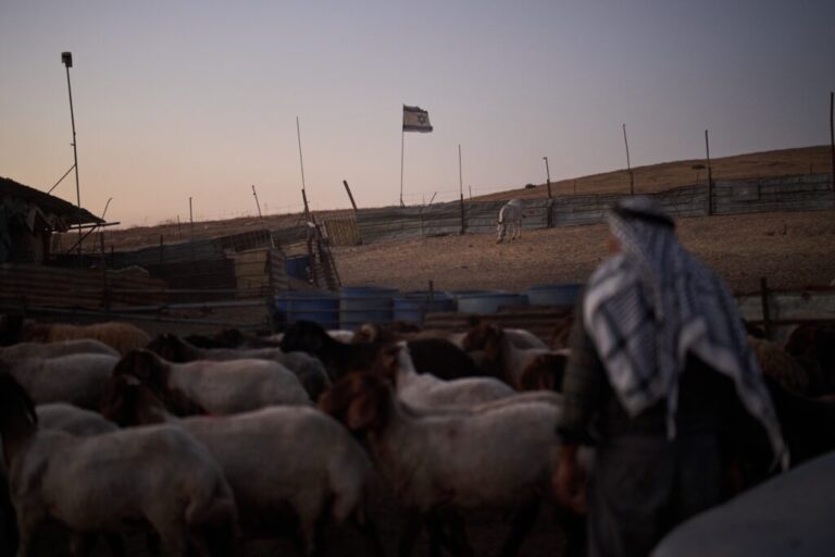 An Israeli flag, set up by settlers, waves beside a fence around a Palestinian compound's sheep pen at dusk in the northern Jordan Valley in the occupied West Bank, Tuesday, June 23, 2026.(AP Photo/Leo Correa)
