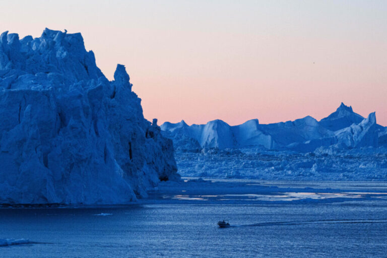 FILE -A boat rides in front of an iceberg at Disko Bay near Ilulissat, Greenland, on Jan. 28, 2026. (AP Photo/Evgeniy Maloletka, File)
