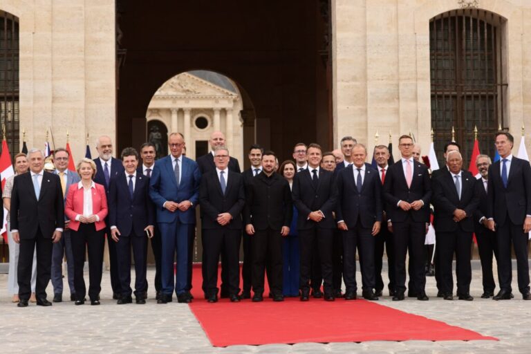 French President Emmanuel Macron and Ukrainian President Volodymyr Zelensky pose for a group photo with heads of states and governments ahead of the Coalition of the Willing summit on security guarantees for Ukraine at the Hotel des Invalides in Paris, France, Monday, July 13, 2026. (Teresa Suarez/POOL photo via AP)