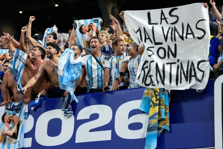 Argentina fans hold a banner with the words