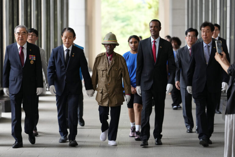 Ethiopian veteran of the Korean War, Tesfaye Asmamaw, 95, walks with South Korean minister of Patriots and Veterans Affairs, Kwon Oh-eul, second from left, in Seoul, South Korea, Tuesday, June 30, 2026. (AP Photo/Lee Jin-man)