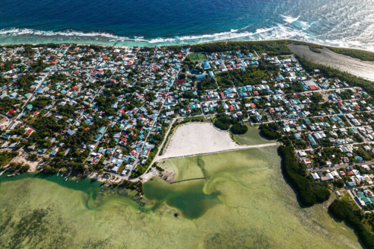 Mangroves line the shore of Hithadhoo Island, part of a UNESCO Biosphere Reserve, with reclamation work visible through it in Addu City, Maldives, June 5, 2026, (AP Photo/Sophia Nasif)