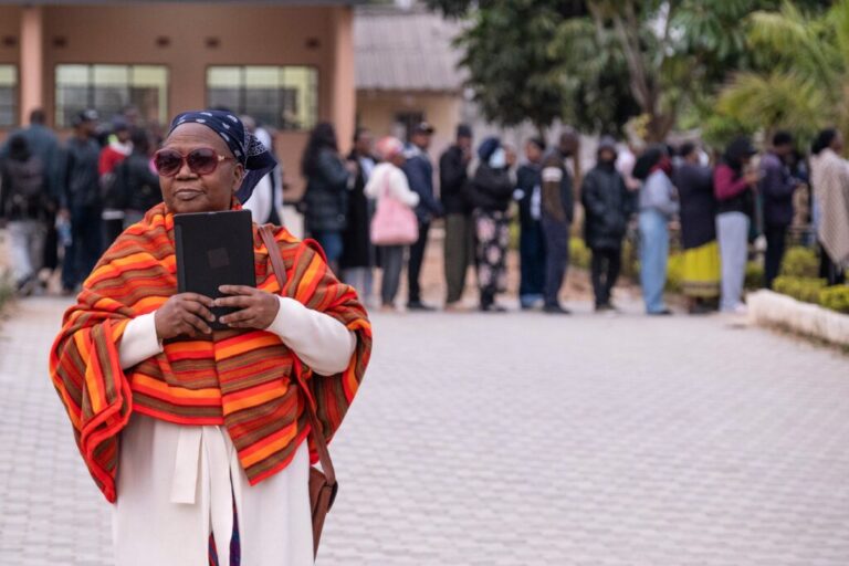 A woman leaves after casting her vote at a polling station in Lusaka, Zambia, Thursday, Aug. 13, 2026. (AP Photo/Anita Reed)
