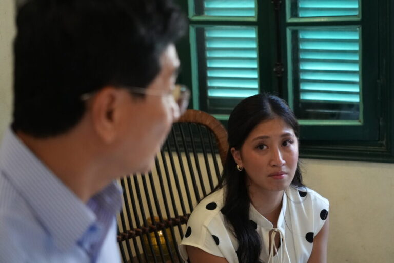 Nguyen Thi Quynh Tam looks at her father after an interview with The Associated Press in Hanoi, Vietnam, Thursday, Aug. 13, 2026. (AP Photo)
