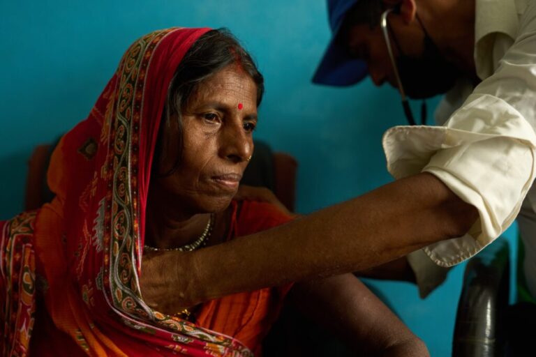 A woman receives an examination from a doctor inside a clinic in Gaur, Nepal, on May 20, 2026. (AP Photo/Bram Janssen)