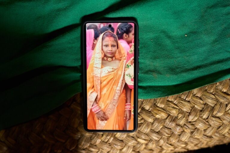 A photo of Kabita Mukhiya, who died during pregnancy, is displayed on a phone on May 19, 2026, in Gaur, Nepal. (AP Photo/Bram Janssen)