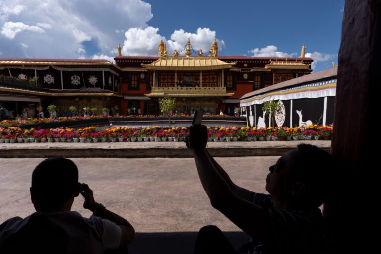 Tourists take in the view at Jokhang Temple in Lhasa in western China's Tibet autonomous region on July 21, 2026, during a government-organized visit for foreign journalists. (AP Photo/Ng Han Guan)