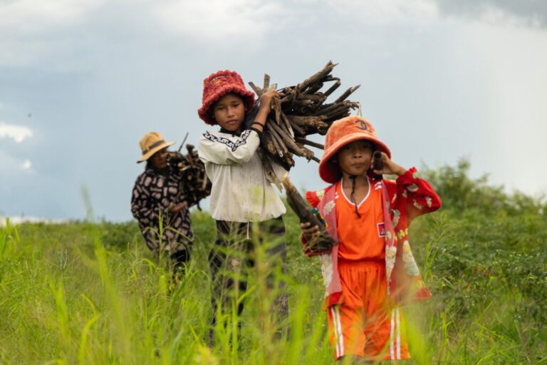 Sou Sreynich, center, collects firewood with her mother and sister near their home in a floating village on Cambodia's Tonle Sap Lake on Monday, June 29, 2026. (AP Photo/Anton L. Delgado)