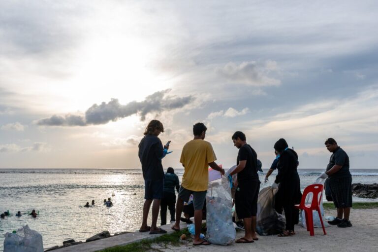 Ripple, a youth group, joins an early morning beach clean up organized by the Ministry of Youth, on Dhiraagu Beach in Hulhumale, Maldives, June 12, 2026. (AP Photo/Sophia Nasif)