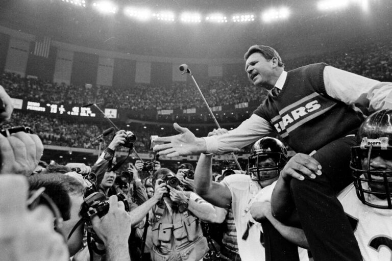 In this Jan. 26, 1986 file photo shows, Chicago Bears coach Mike Ditka reaches out to shake hands with New England Patriots coach Raymond Berry after the Bears won the NFL football Super Bowl XX game in New Orleans. (AP Photo/File)