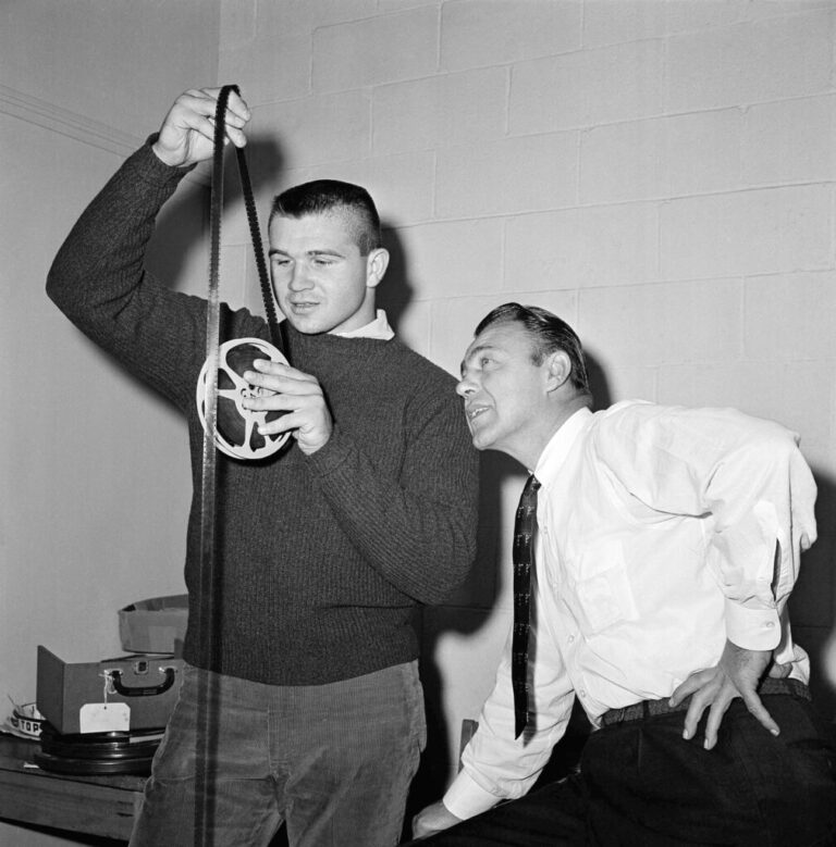 Big Mike Ditka, named lineman of the week by the Associated Press, looks over film of the Notre Dame squad with Pitt coach Johnny Michelosen, Nov. 2, 1960 in Pittsburgh. (AP Photo/File)