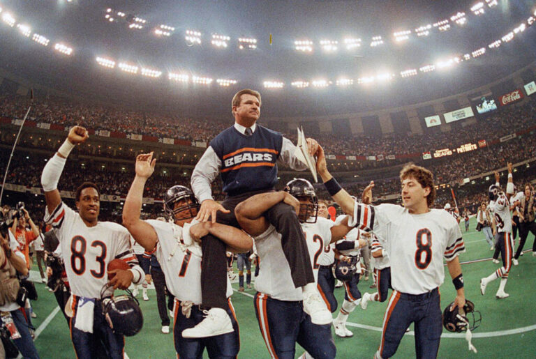 In this Jan. 26, 1986, file photo, Chicago Bears coach Mike Ditka is carried off the field by Steve McMichael, left, and William Perry after the Bears defeated the New England Patriots 46-10 in NFL football's Super Bowl XX in New Orleans. Willie Gault (83) and Maury Buford (8) join the celebration. (AP Photo/Phil Sandlin, File)